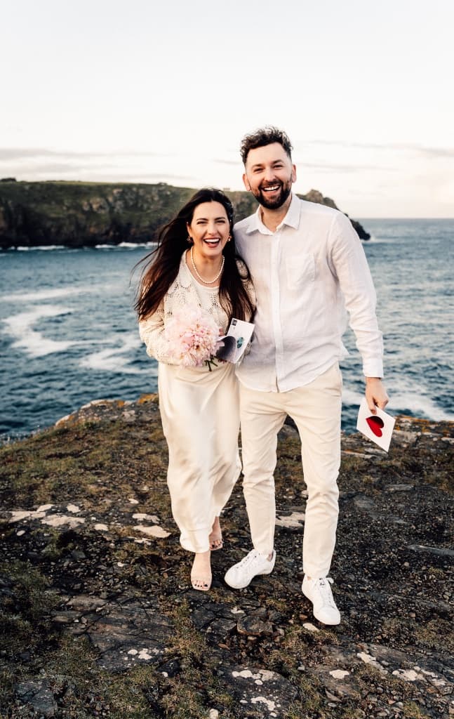 Couple laughing by the sea