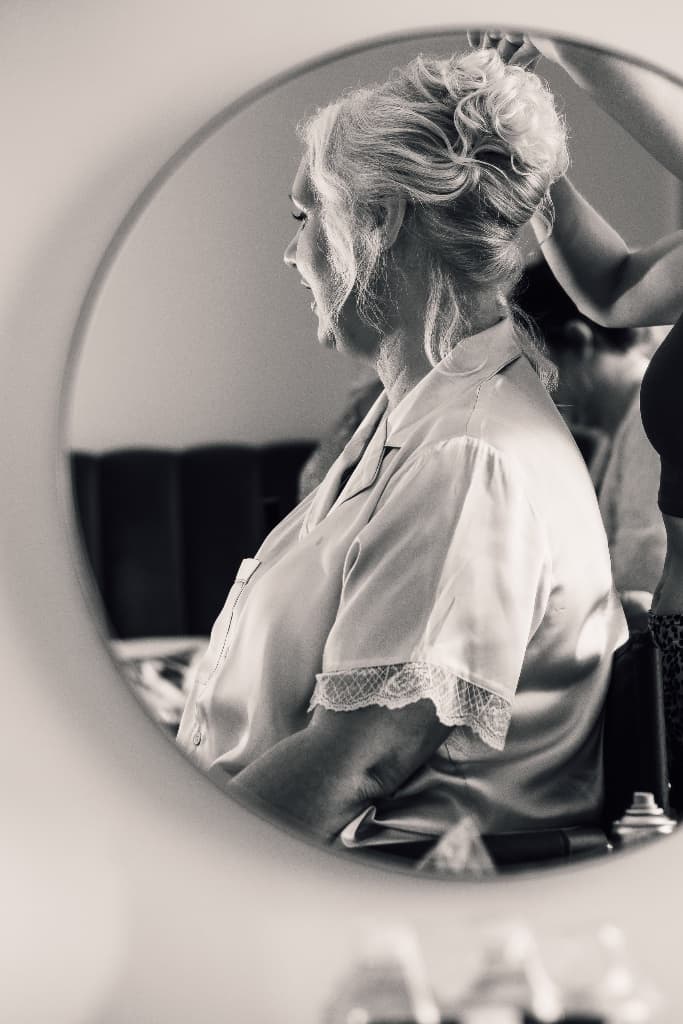 Bride getting ready in mirror